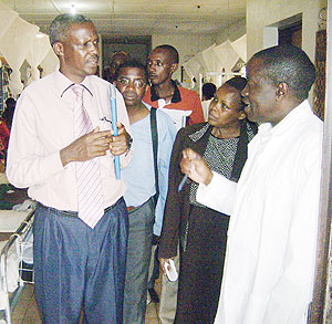 Dr. Adolphe  Karamaga, Rwinkwavu  Hospital Director (Right in gown) talking to Fu00e9lix Ntungumburanye, the Burundian HIV National Director. (Photo: S. Rwembeho)