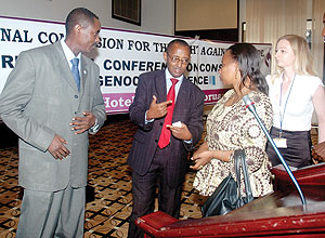 CNLG Executive secretary Jean de Dieu Mucyo listens to his staff Deogene Bideri and Christine Tuyisenge, with Amanda Roberts a forensic expert (R) during a conference on preservation of Genocide evidence. (Photo J Mbanda)