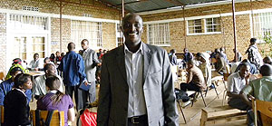 NUR Legal Aid Clinic Coordinator, Aimable Havugiyaremye, poses for the camera. In the background are clients and their students (Photo B.Kimenyi)