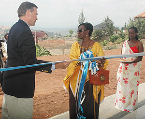  Rosette Rugamba cuts the ribbon to open the new centre while US Ambassador, Stuart  Symington, looks on. (Photo F.Goodman)