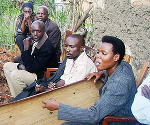 Kirusuu2019s daughter Sophia Nzayisenga plays one of her fathers favourite songs after the burial.  Photo: D.Sabiiti