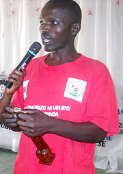 One of the persons living positively, demonstrates how the condom is used properly during the campaign. 