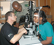 Prof. Geoffrey Taban examines an eye patient as Dr Maj. John Nkurikiye  looks on at King Fisal Hospital. (Photo J Mbanda)