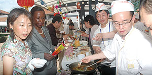 Foreign Affairs Minister Louise Mushikiwabo (2nd left) being shown some of the  food at the Chinese food Festival in Kigali Yesterday.(Photo J Mbanda)
