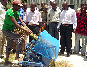 A local rice farmer demonstrating the use of  the newly introduced rice thresher.(Photo / P.  Ntambara)