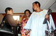 MPs  Aurelie Gahongayire , Constance Mukayuhi Rwaka and Faith Mukakarisa chat after the workshop yesterday. (Photo J Mbanda)