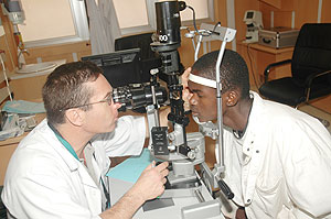 Prof. Geoffrey Taban conducts a follow-up examination on Joseph Rugemandinzi yesterday. The eye patient underwent a Conea transplant in July last year. (Photo/ J. Mbanda)