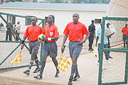 JOB WELL DONE: Hudu Munyemana (C), Celestin Ntagungira (R)and Eric Ruhamiriza (L) take to the field to officiate a local league match between Rayon Sport and Atraco. (File photo)