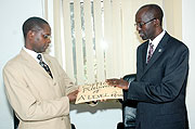 State Minister for Primary and Secondary Education Mathias Harebamungu receiving 2009  A Level results from RNEC Executive Secretary John Rutayisire yesterday. (Photo J Mbanda)