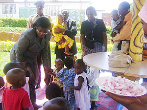 The Minister of Gender and Family Promotion Jean d`Arc Mujawamariya shares a light moment with the children before they were allocated (Photo G.Mugoya)