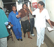 Hospital workers leading one of the injured. (Photo/F. Goodman)