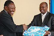 Agrey M. Mwanri, Tanzaniau2019s deputy minister in the PM's office exchanging a gift with Minister James Musoni yesterday (Photo J Mbanda)