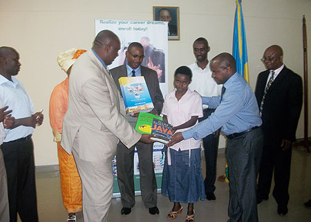 Simon Gicharu, Chairman and founder of Mt Kenya university awards text books to one of the best students(Photo/ G. Mugoya)