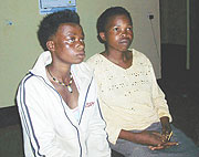 UNDER ARREST:  Yvonne Nyarihabimana (L), 17 and Claudine Mukabyenda, 38 at Muhanga sector cell. (Photo/ D.Sabiiti)