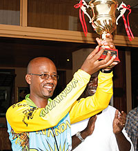 President of the national cycling federation Aimable Bayingana shows off Team Rwandau2019s trophy on Sunday.