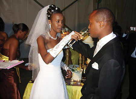 Gatete and Hakizamungu share a drink at the reception in Gikondo.