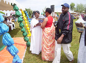The Vice President of the Senate Marie Mukantabana(L) being presented with a gift from Gicumbi District Women at Cyumba Sector. (photo/ A.Gahene)