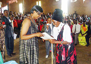 Dative Mukabalisa Simbi presents a certificate of merit to Jeanne Mukakarera, on Monday. 