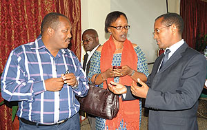 CNLG Commissioner Jean Pierre Dusingizemungu (L) talking to Coordinator of Mental Health,Yvonne Kayiteshonga and Deogene Bideri of CNLG. (Photo J Mbanda)