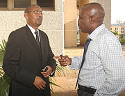 TAKE NOTE; Minister of Finance John Rwangombwa chatting with Abbas Mukama outside parliament.  (Photo; F.Goodman).
