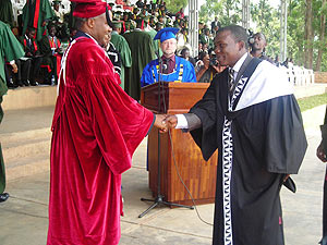 The Minister of Education, Dr. Charles Murigande congratulates one of the four students who attained a First Class degree at NUR yesterday. (Photo; P. Ntambara)