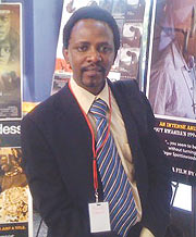 Ndahayo poses for the camera next to a poster depicting his movie at Culver Plaza Theatres. (Courtesy photo)