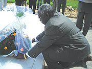 Dr.William Shija laying a wreath on grave at Murambi genocide memorial site in Nyamagabe district. (Photo/ J. Bucyensenge)