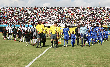 GRAND ENTRACE:  APR and TP Mazembe teams enter the field for yesterdayu2019s Orange Champions League clash at a fullpacked Amahoro national stadium. APR won the first leg tie 1-0. (Photo/ N. Etienne)