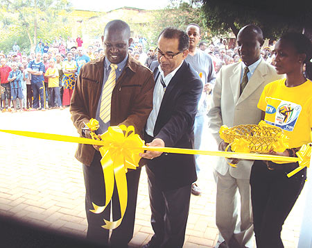 Jean Marie Makombe (L) helped by MTN officials to officially open the service centre. (Photo/ S.Rwembeho)