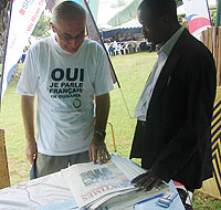 The French ambassador to Uganda, talking to The New Timesu2019 marketing executive Henry Lyadda during the exhibition. (Photo/ E. Kabeera)