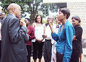 The Director General of Rwanda Cooperatives Agency (RCA), Damien Mugabo discusses with some of the Umurenge Sacco accountants. (Photo: D. Sabiiti)