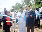 Minister Coletha Ruhamya (C) cuts the tape during the inauguration of a water project in Huye. (Photo: J.C Gakwaya)