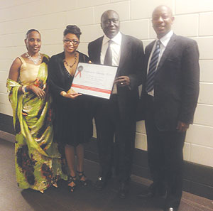 Minister of Justice, Tharcisse Karugarama (2nd from right) holding  the Diversity award. With him are Second Counsellor Enid Mbabazi, u2018Unity is the Strengthu2019 representative Nadya van Pottens, the Charge du2019 Affaires a.i, Parfait Gahamanyi.(Courtesy photo)
