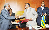 Permanent Secretaries Eugene Munyakayanza of Rwanda and his Kenyan counterpart, Thuita Mwangi,  after signing. Right is Rwandau2019s envoy to Kenya Bill Kayonga. (Photo J. Mbanda)