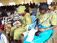 Women leaders taking notes during the work shop. (Photo by S. Rwembeho).