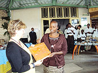 Muhanga Vice Mayor, Alice Uwimbabazi hands over a symbol of the newly  founded partnership to a Scottish  delegate, (Photo D.Sabiiti)