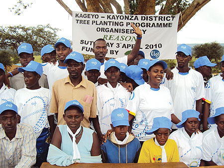 TIGO staff and pupils of Rwisirabo primary school pose for a photo after planting trees. (Photo/ S. Rwembeho)