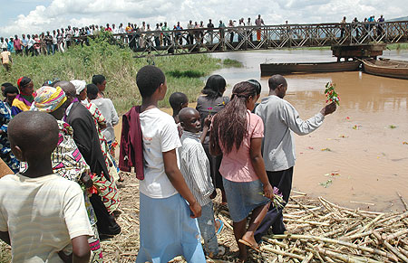 Relatives and friends of victims who were dumped into River Nyabarongo throwing flowers into the river (photo J. Mbanda)