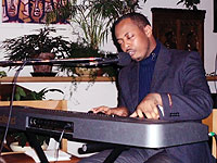 Kizito Mihigo playing a keyboard