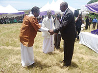 Rwandan High Commissioner to Uganda Frank Mugambage welcoming one of the Ugandan guests to the commemoration event on Wednesday (Photo E Kabeera)