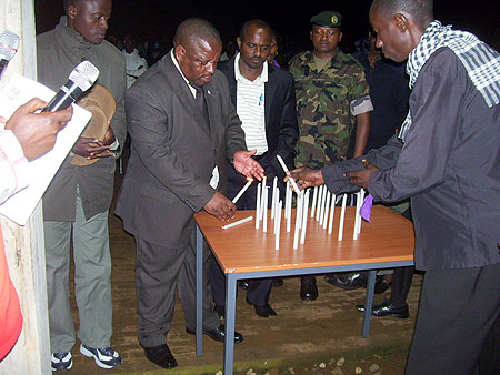 Governor Aime Bosenibamwe lights a candle during genocide commemoration at Tumba College of Technology. (Photo / A. Gahene)