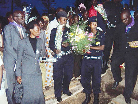 RIP: Police officers pay their last respects to their colleagues whose bodies were recovered yesterday. (Photo: S. Nkurunziza)