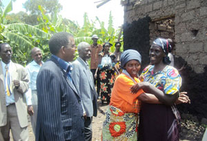 Pelagie Nirere (R), gets a hug of peace from the mother of those who destroyed her house during the genocide as others look on. (Photo: D. Sabiiti)