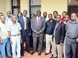 Ministers Tharcisse Karugarama and Stanislas Kamanzi pose for a photo with the newly sworn in land legal advisors. (Photo: S. Rwembeho)