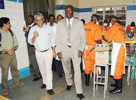 The Minister of Labour, Anastase Murekezi (L) touring SULFO Industries premises accompanied by the companyu2019s Director H. Dharmarajan (R). (Photo J. Mbanda)