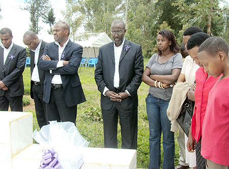 The Managing Director Access Bank Jean Claude Karayenzi (centre) and orphans memory of the genocide victims. (Photo/ S. Rwembeho)  