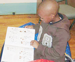 A child reading. Rwandan authors should be given more support.