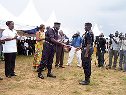 The Commissioner General of Police, Emmanuel Gasana handing over a certificate to a policeman who completed a course in fighting GBV yesterday. (Photo; A.Gahene)