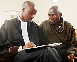 DENIED BAIL: Capt. Jean Marie Vianney Karuta (R) with his lawyer in court last week (File photo)