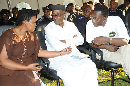 GMO chief Oda Gasinzigwa talks to the Mufti Saleh Habimana (C) and Pastor Antoine Rutayisire  during the Anti GBV campaign at Police Headquarters yesterday (Photo J Mbanda)